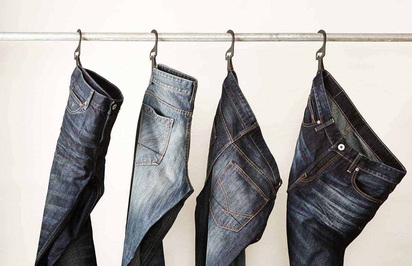 Man wearing jeans folding up pant leg - Stock Image - Everypixel