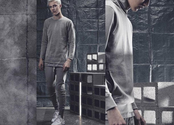 Person in gray loungewear in industrial setting. Close-up partial frame shot.