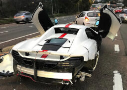 White McLaren with red stripe, damaged rear.