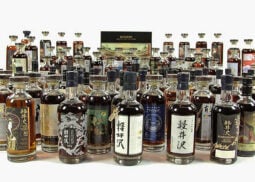 Diverse whiskey collection, featuring Japanese whisky bottles.