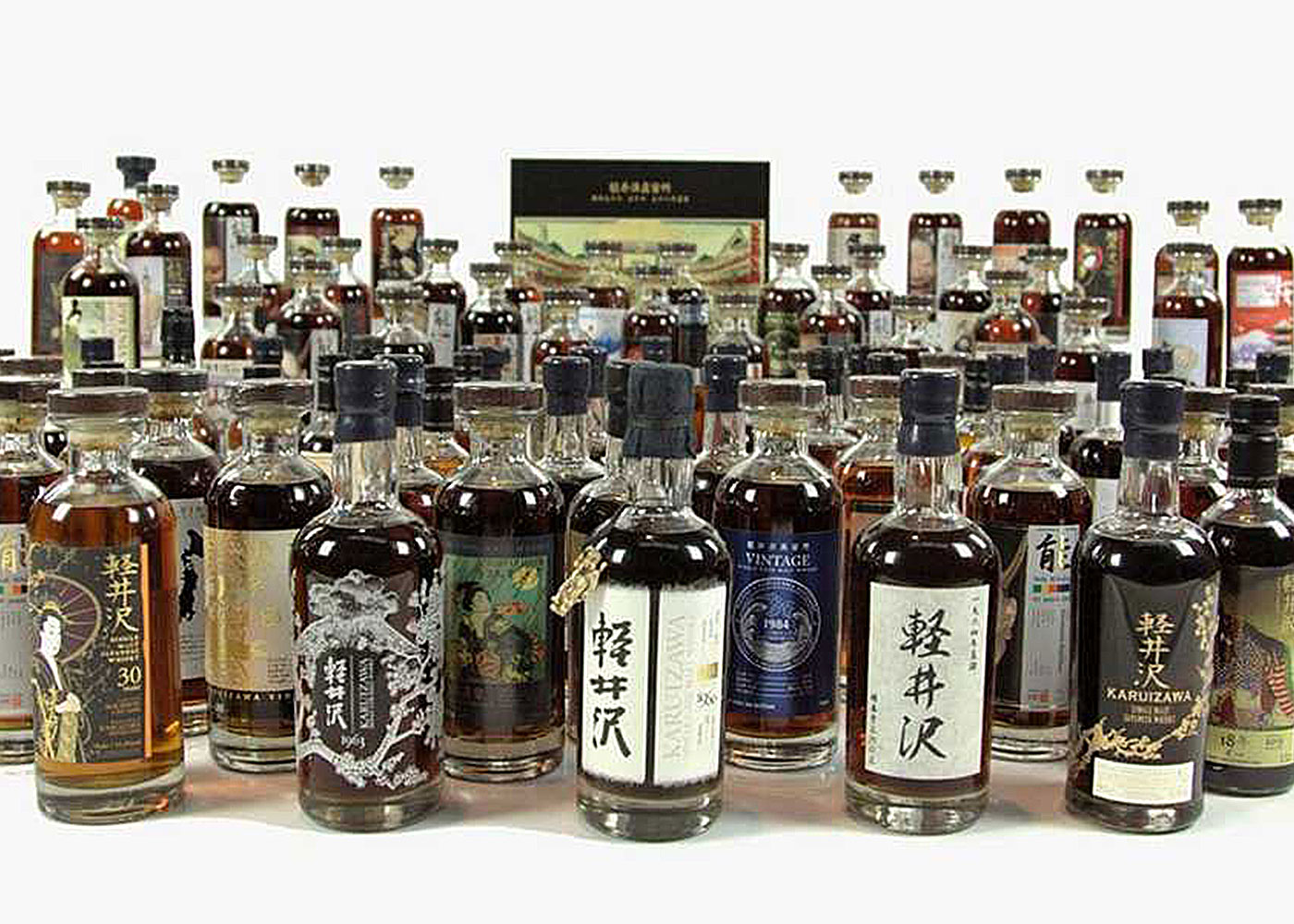 Diverse whiskey collection, featuring Japanese whisky bottles.