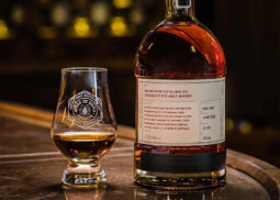 Archie Rose Chocolate Whisky beside filled glass.
