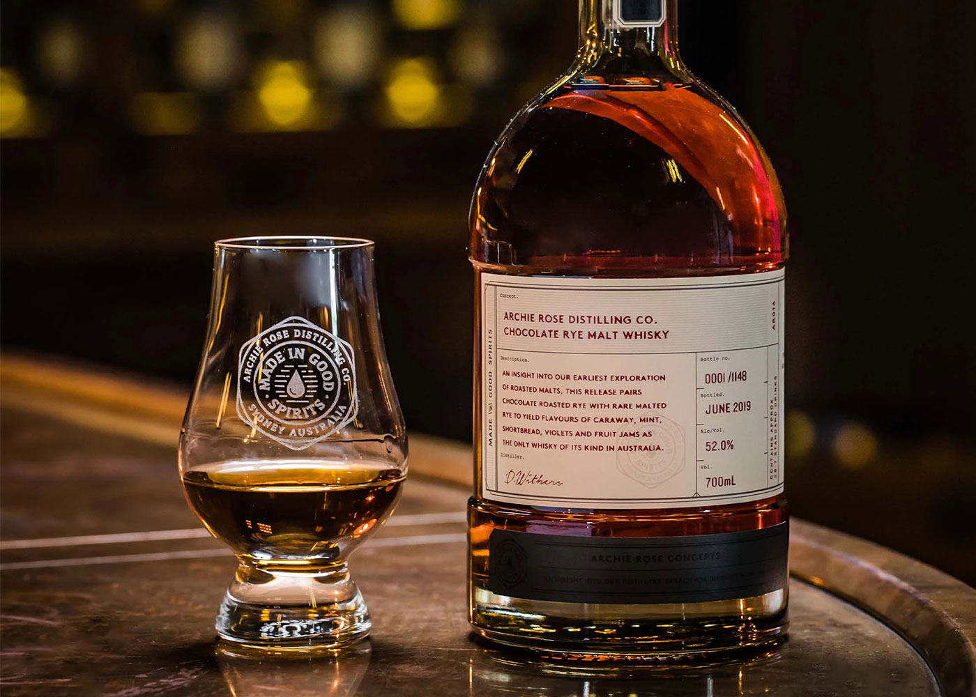Archie Rose Chocolate Whisky beside filled glass.