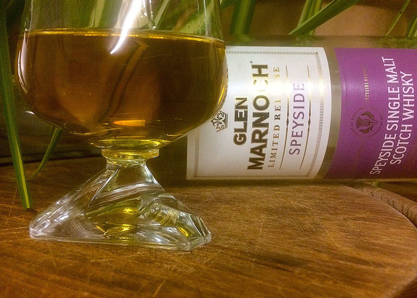 Glen Marnoch whisky bottle beside amber glass.