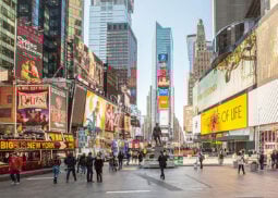Pedestrians and tour bus in Times Square.