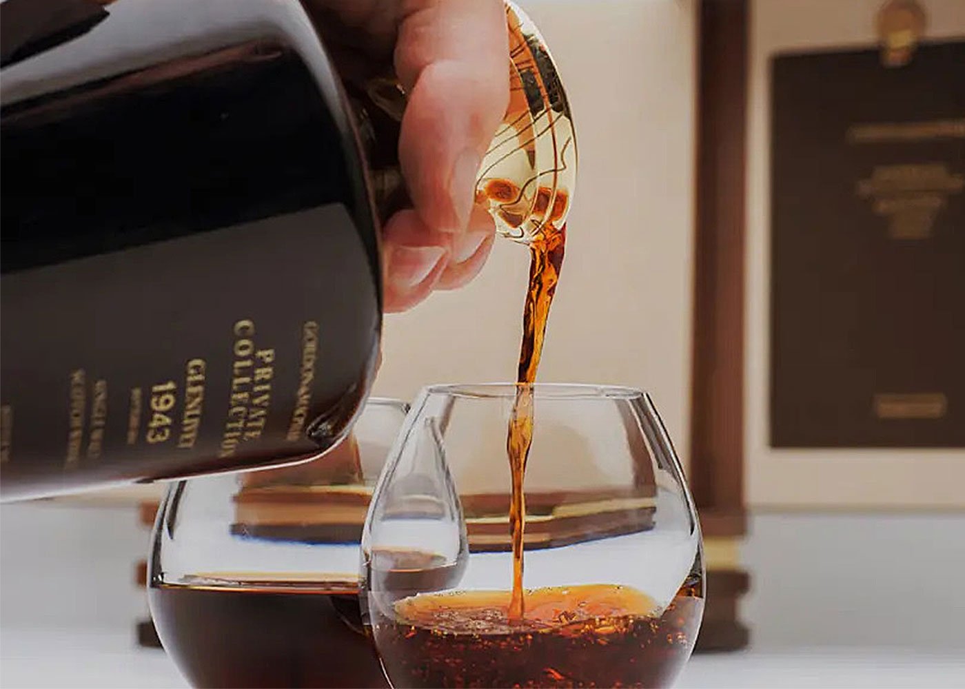 Pouring 1943 whisky into a glass.