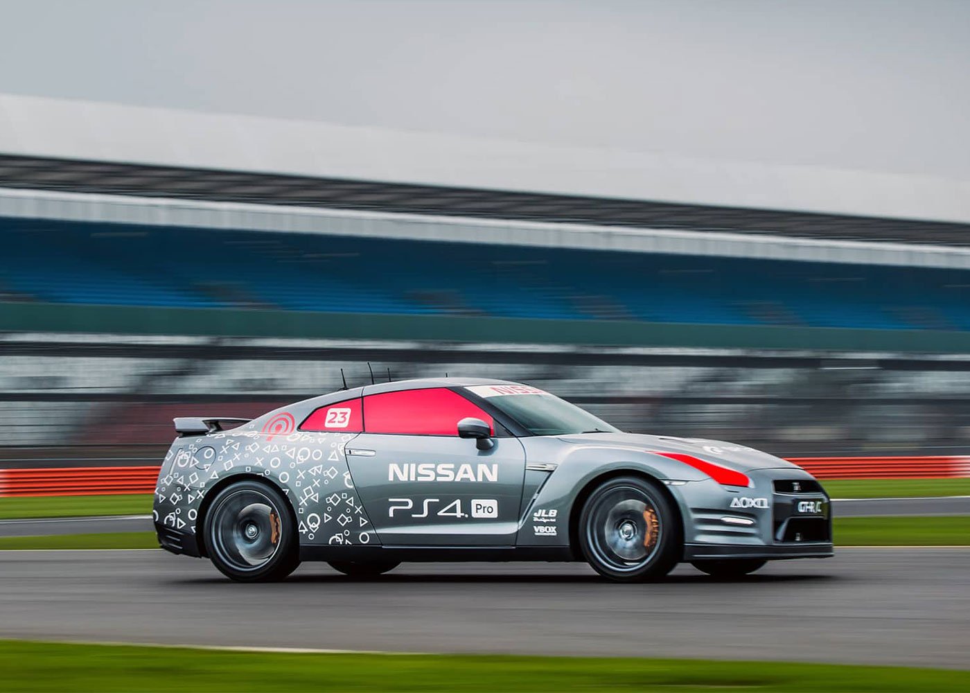 A Nissan sports car races with PS4 Pro branding.