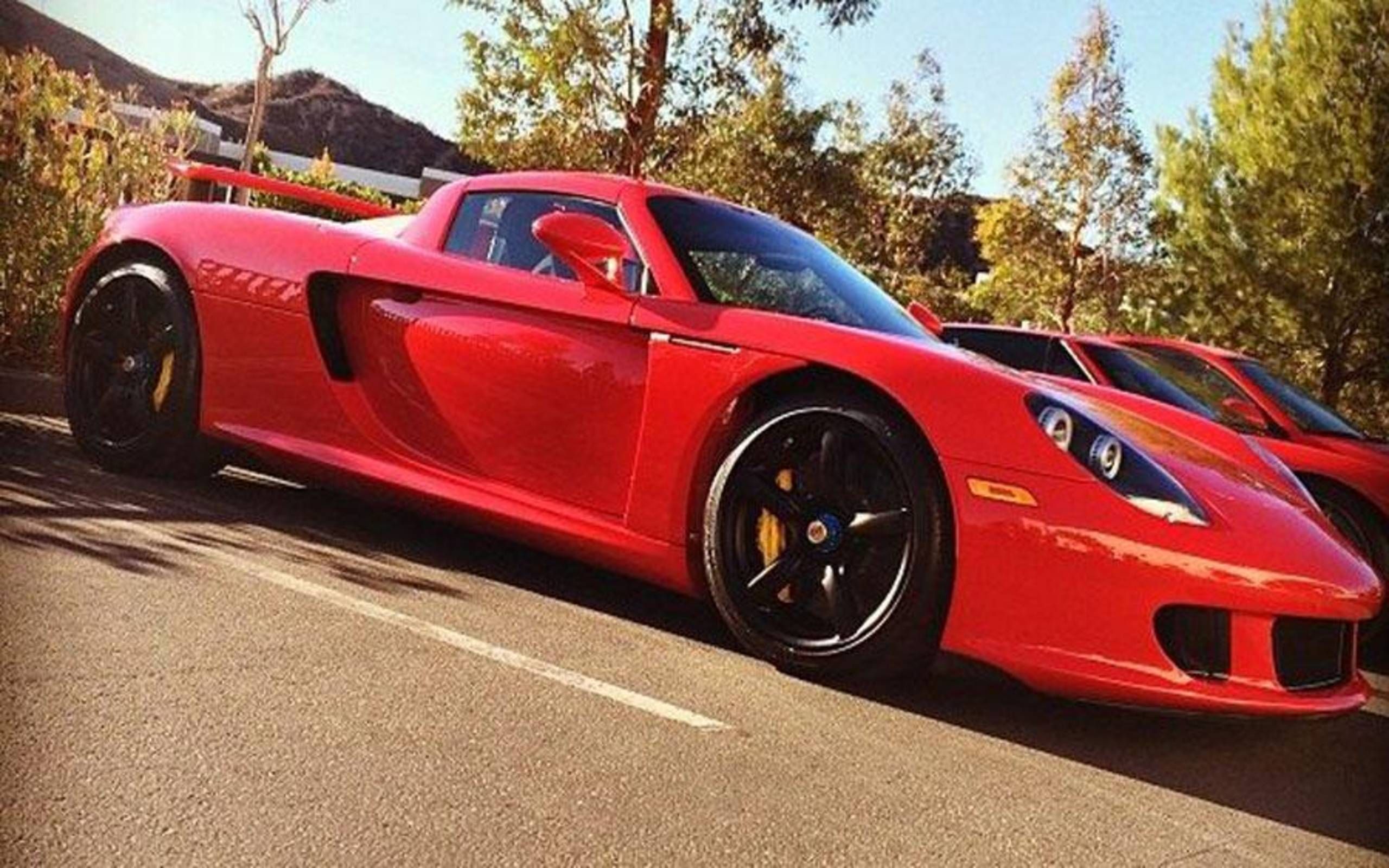 Paul Walkers Red Porsche with spoiler parked outside.