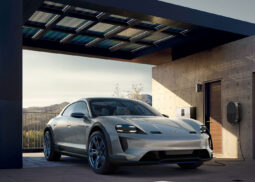 Porsche Mission E near solar-covered carport, charging.