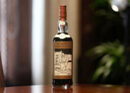 The Macallan 1926 Whisky bottle on wood surface.