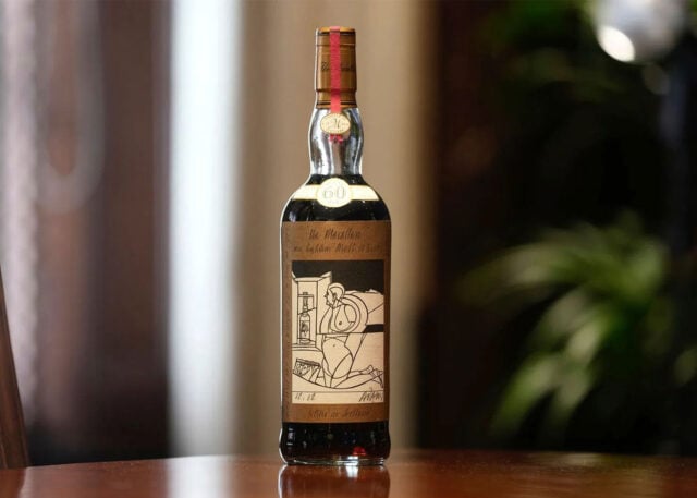 The Macallan 1926 Whisky bottle on wood surface.