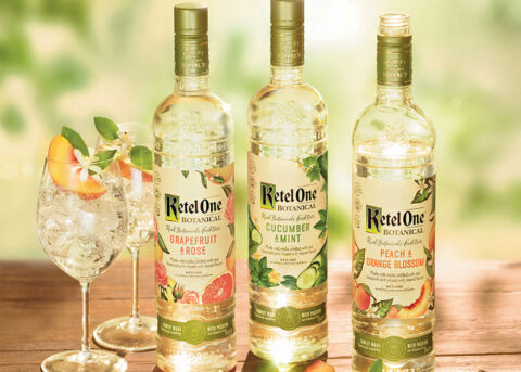 Ketel One vodka bottles with cocktail glasses.