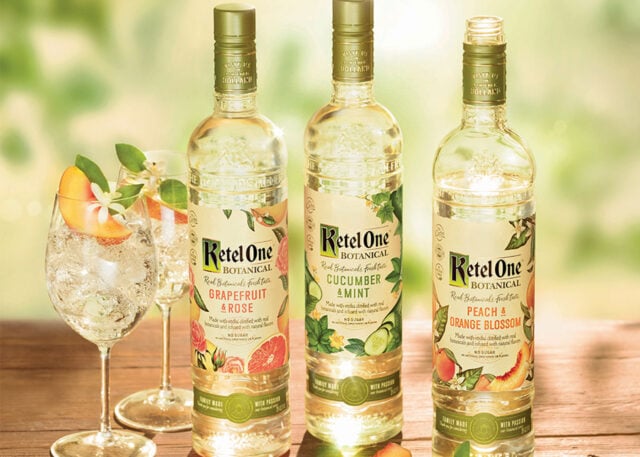 Ketel One vodka bottles with cocktail glasses.