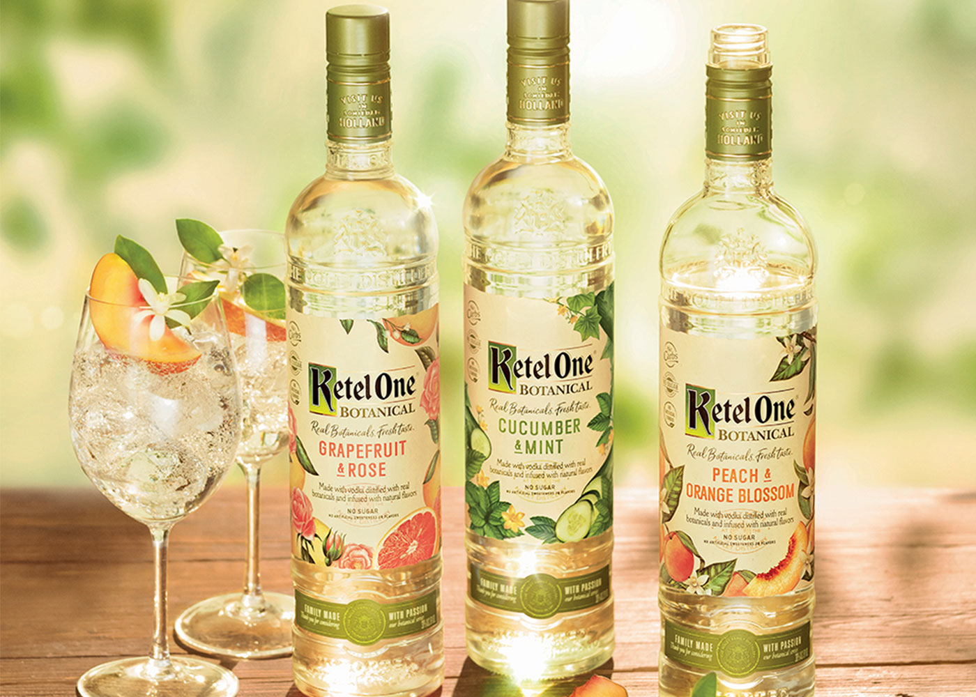 Ketel One vodka bottles with cocktail glasses.