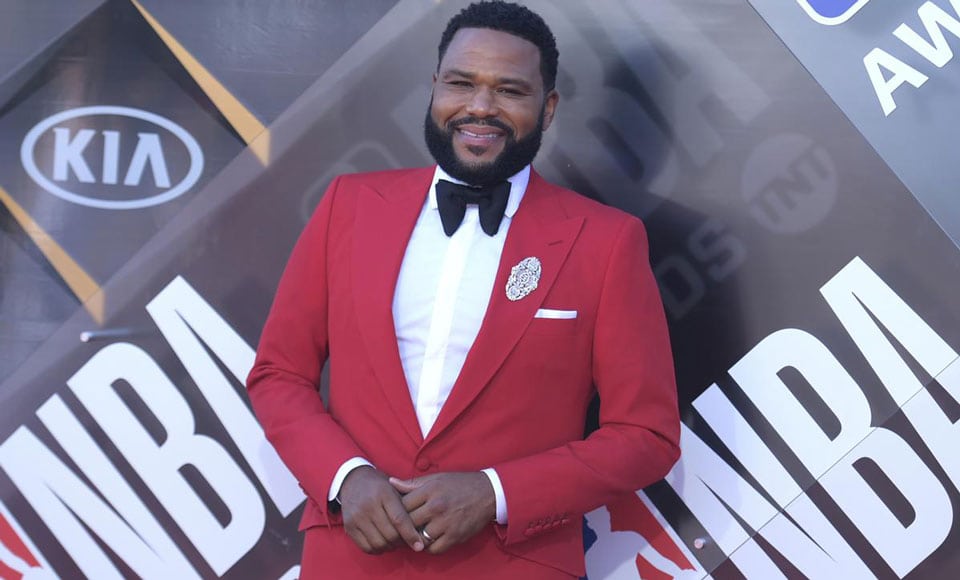 A plus size man wearing a red suit and bow tie.
