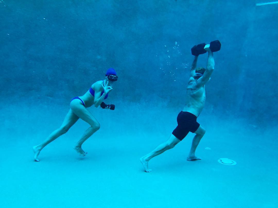 Underwater workout: Dumbbells, goggles, Laird Hamilton inspiration.