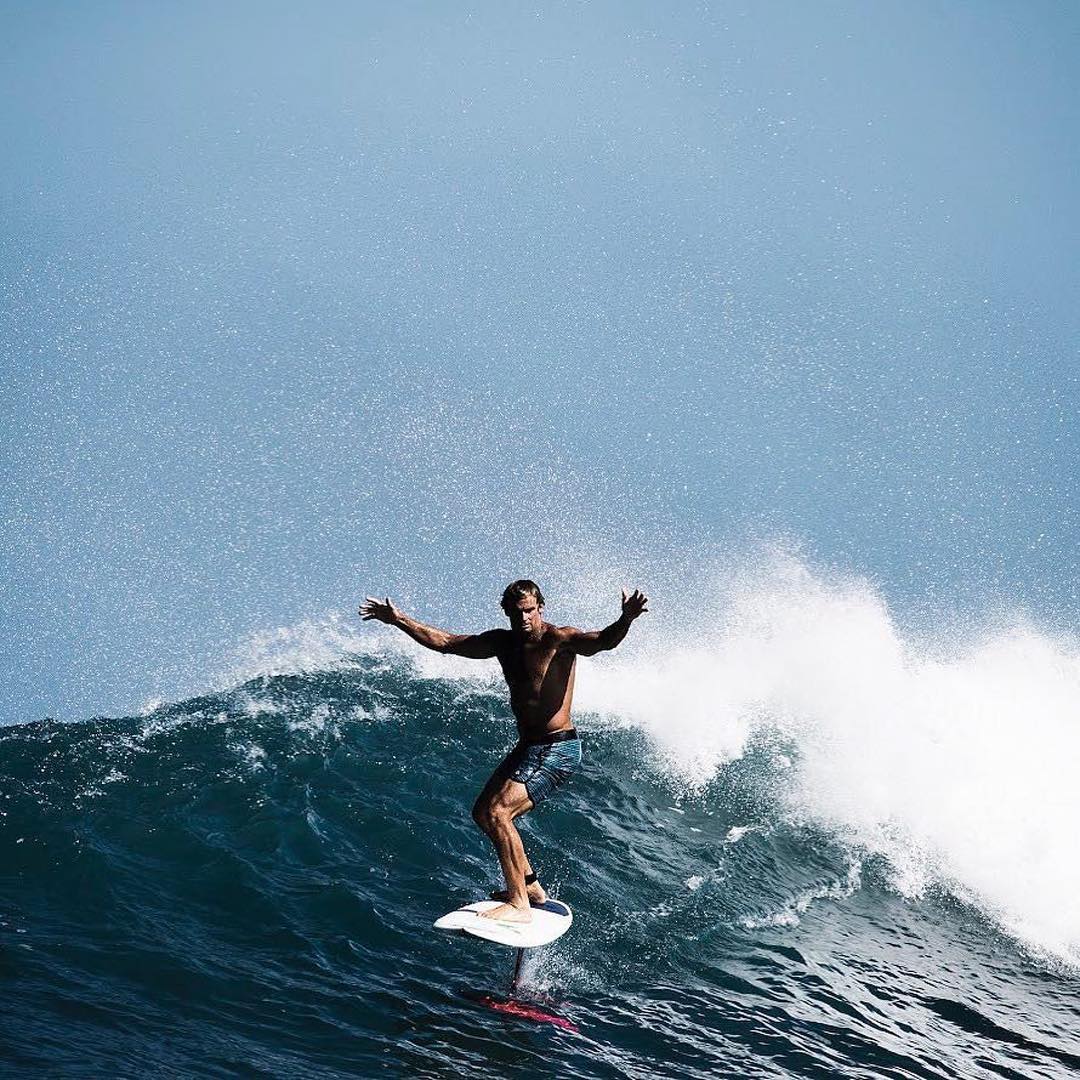 Surfer on hydrofoil board mimics Laird Hamilton.