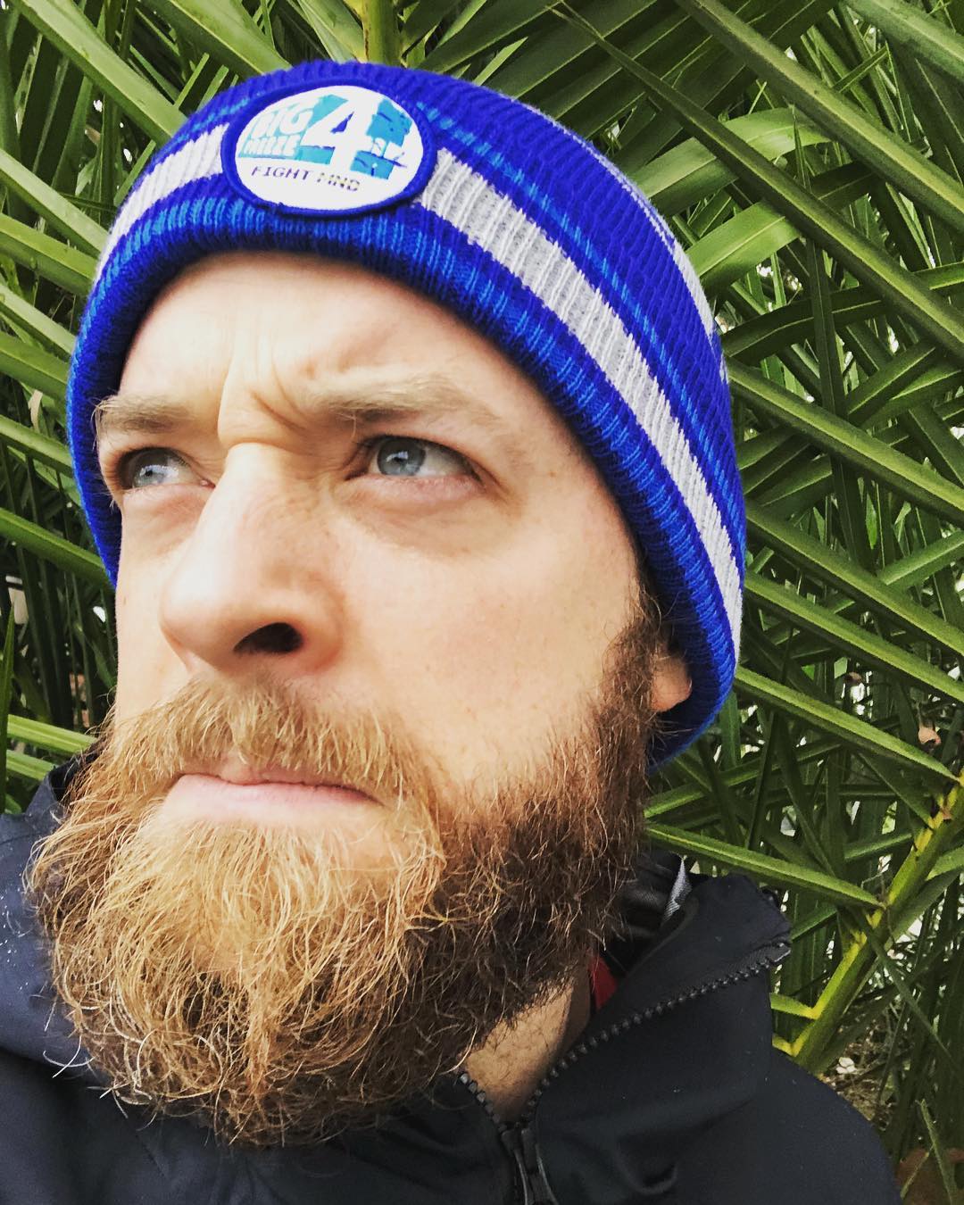 Hamish Blake lookalike in beanie pondering beard impact.