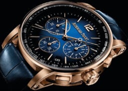 Luxury watch: gold case, blue dial, tachymeter.