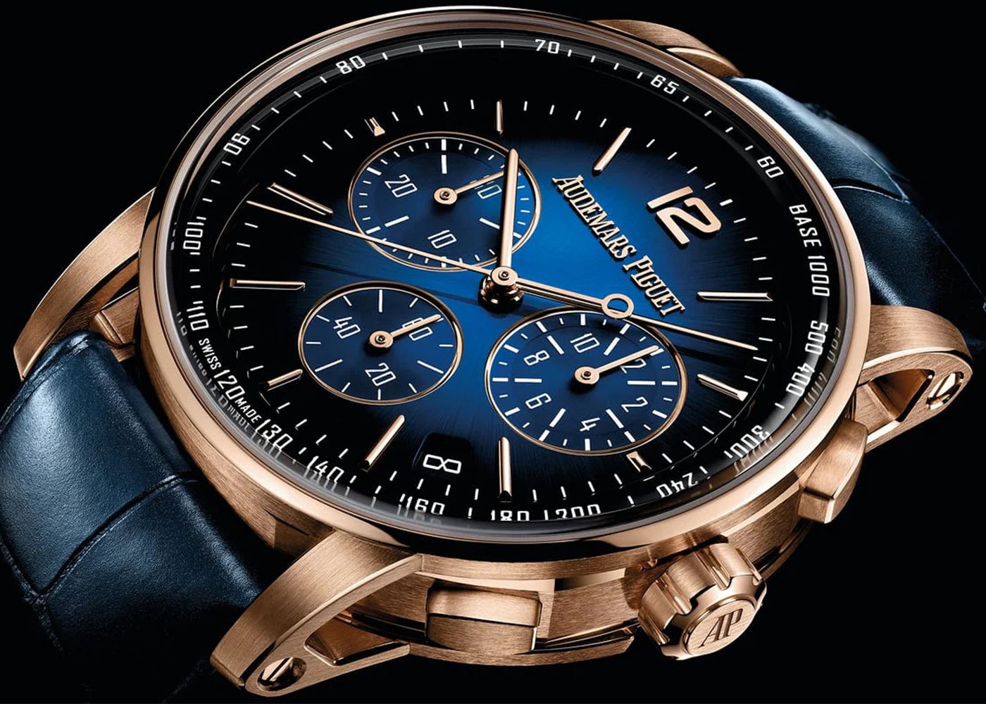 Luxury watch: gold case, blue dial, tachymeter.