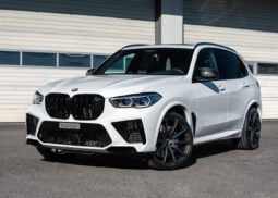 White BMW X5 with black wheels parked stylishly.