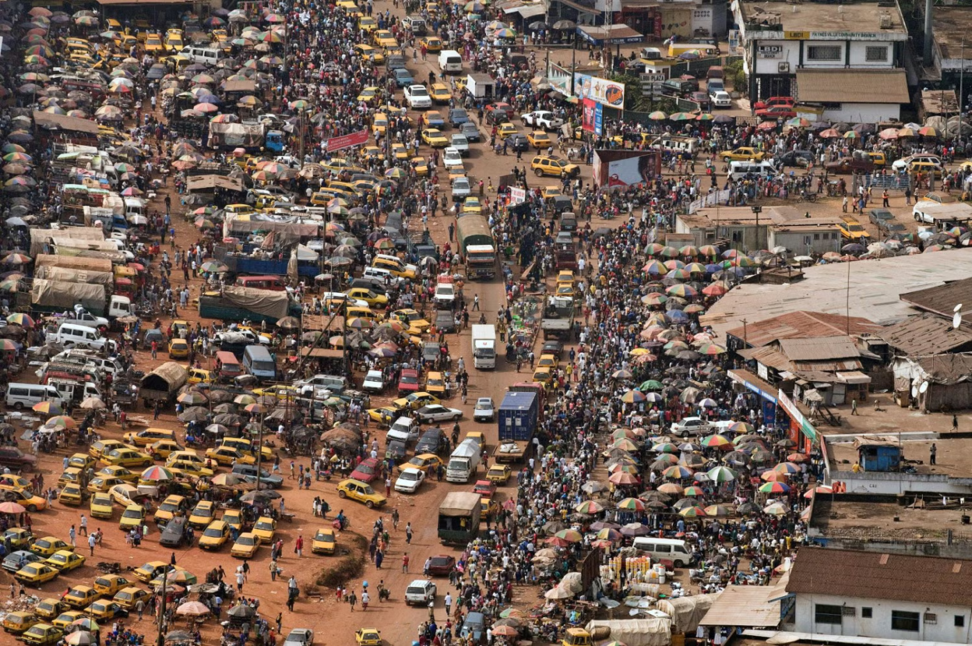 Aerial view of bustling market and taxis.