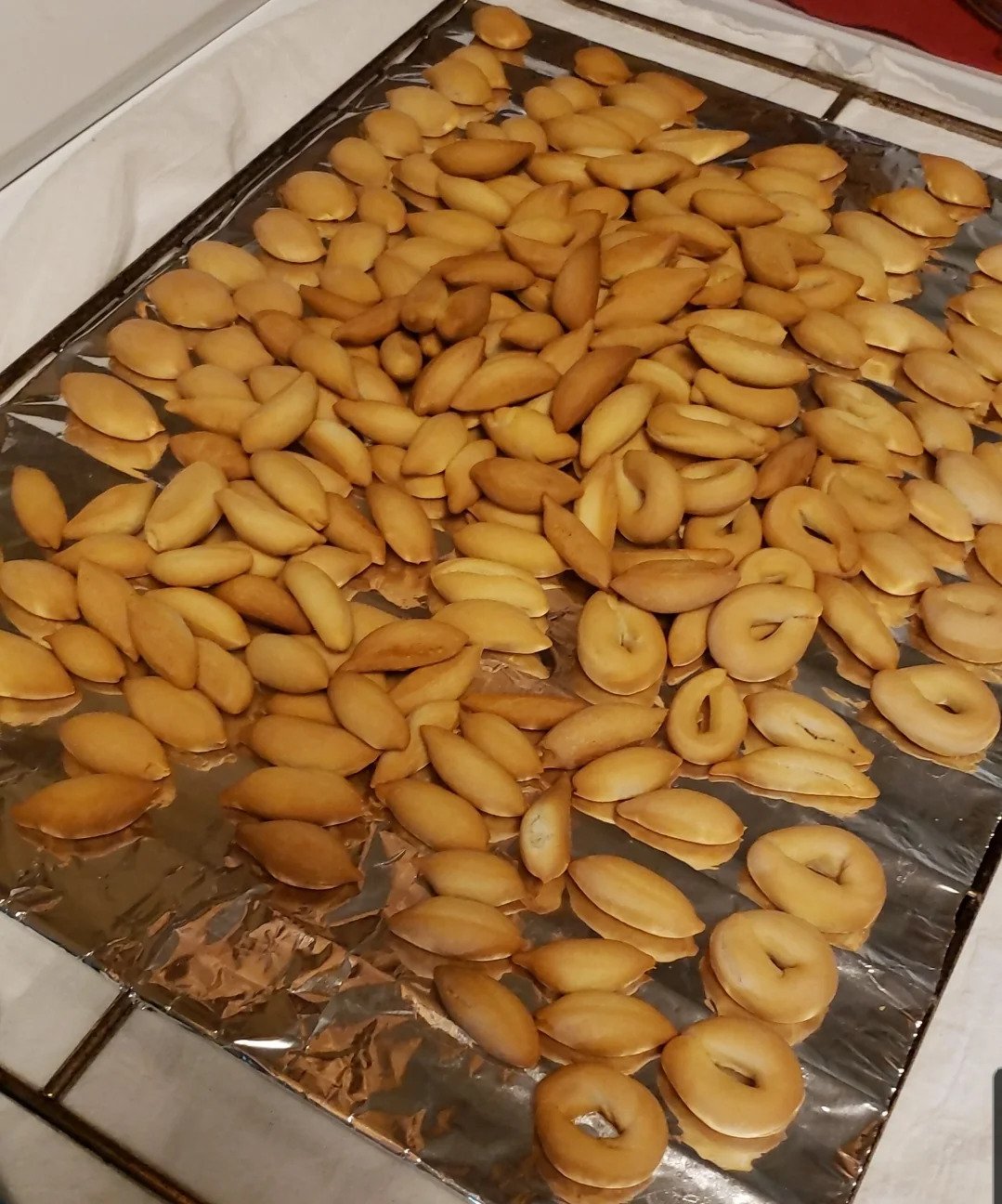 Oval, Spanish-inspired cookies on foil-lined tray.