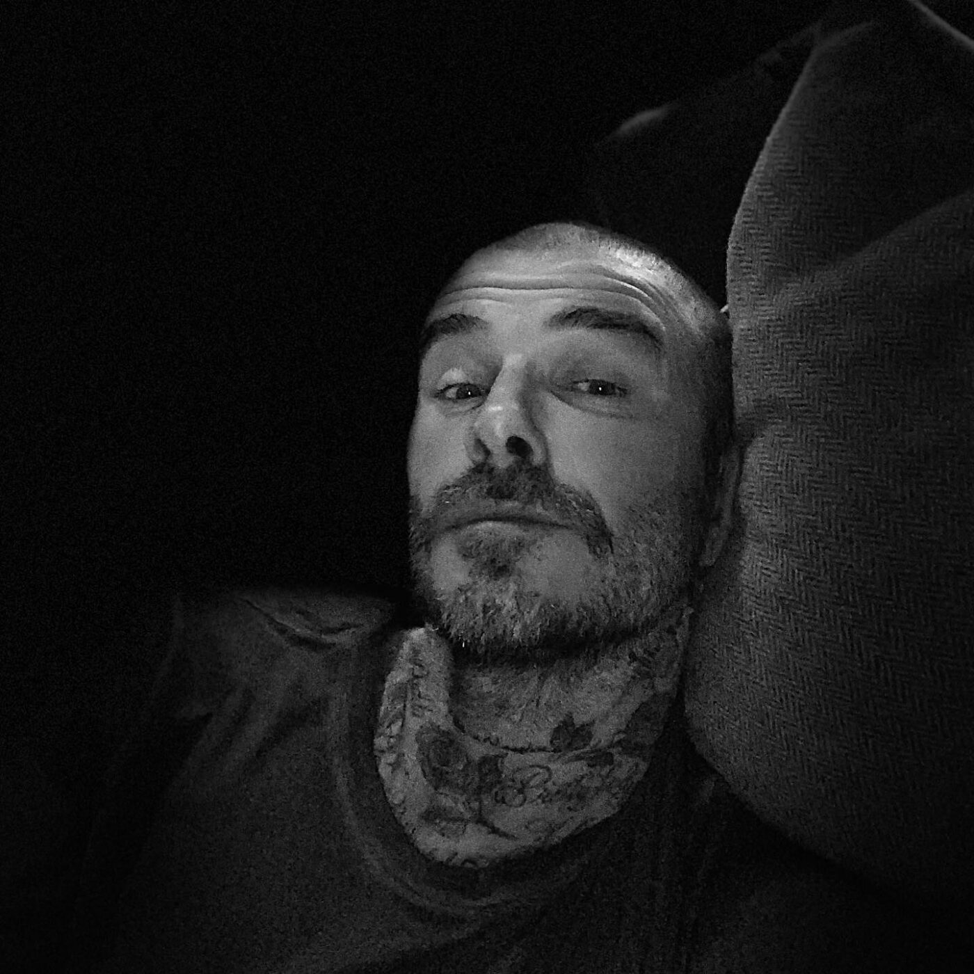 Buzz cut, relaxed, Beckham-like pose.