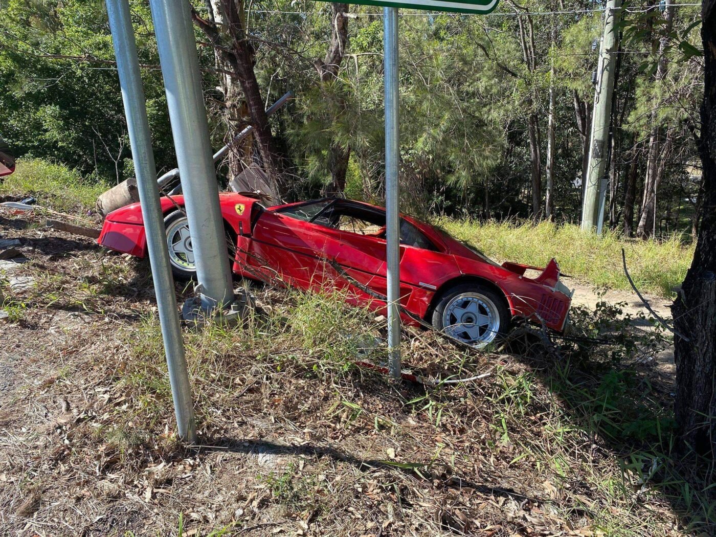 Red Ferrari crashed off-road in Queensland, uninsured.