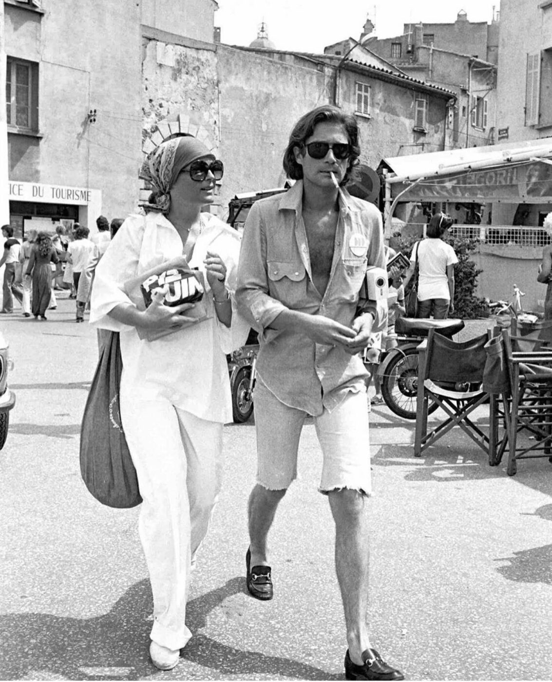 A chic couple strolls through exotic streets.