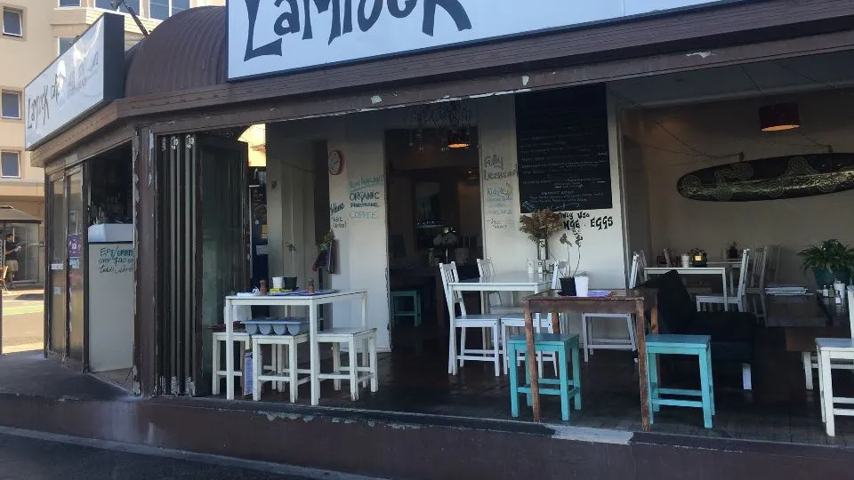 Lamook café's inviting exterior with menu displayed.
