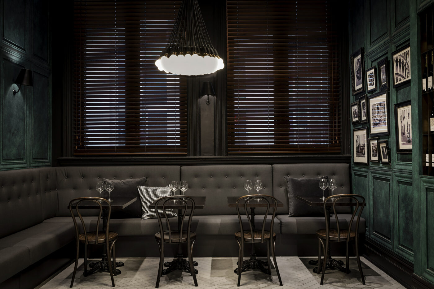 Cozy dining area with green walls, wood furniture.