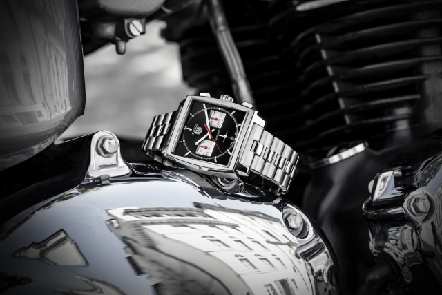 TAG Heuer Monaco watch on motorcycle engine.