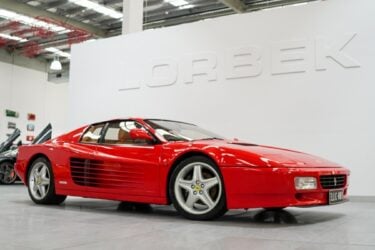 Red Ferrari Testarossa displayed at Lorbek showroom.