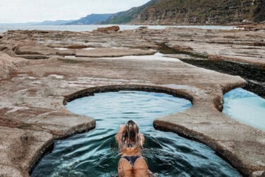 Swimmer enjoys Figure 8 Rock Pools' beauty.