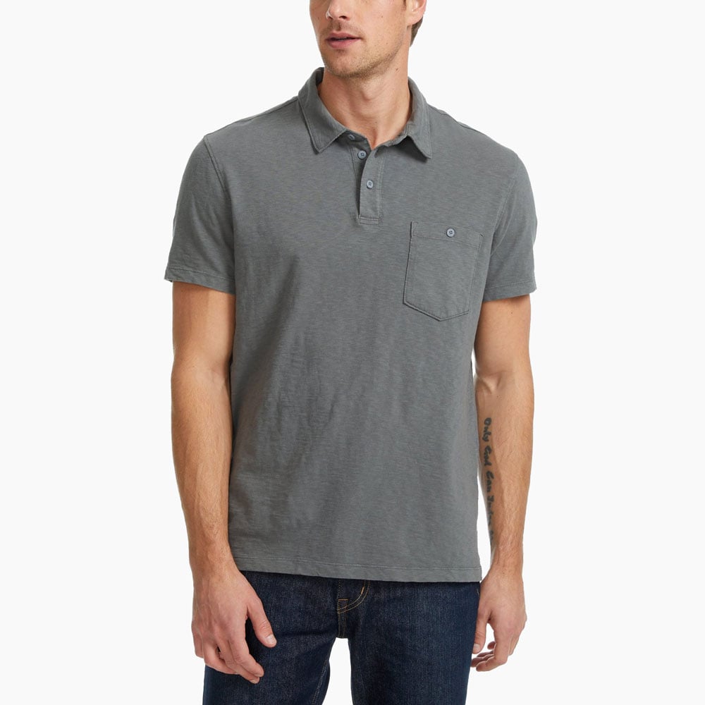 Man in gray polo and jeans outfit.