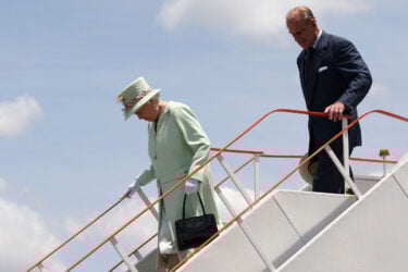 Elderly woman descends plane, embodying British Royals.