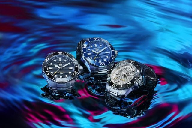 TAG Heuer Aquaracer watches on reflective surface.