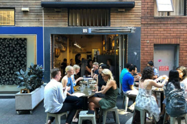 People at Sydney cafe, chatting outside.