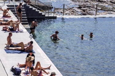 Coastal pool in Australia with sunbathers and swimmers.