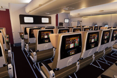 Economy flight cabin with individual touchscreens.