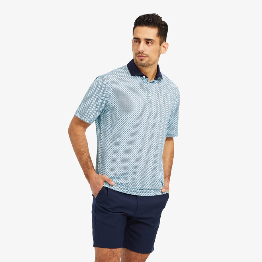 Man models light blue polo with shorts.