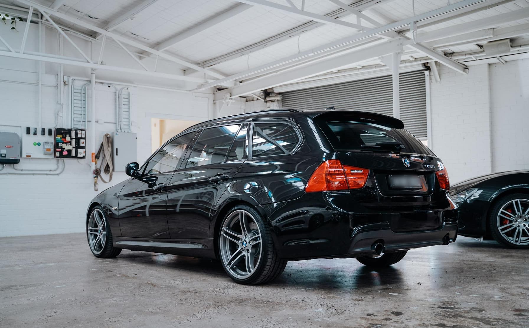 Black station wagon with tinted windows parked.
