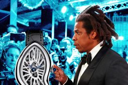 Man in tuxedo displays Cartier watch at event.