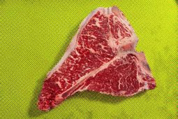 T-bone steak on yellow surface, Aussie style.