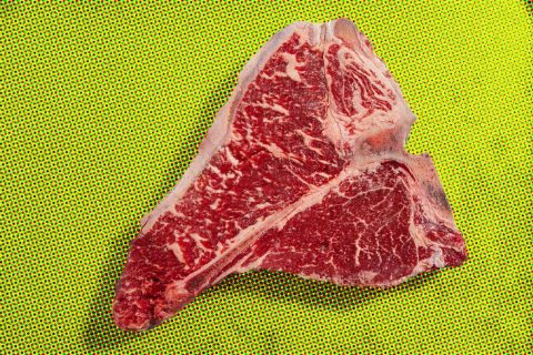 T-bone steak on yellow surface, Aussie style.
