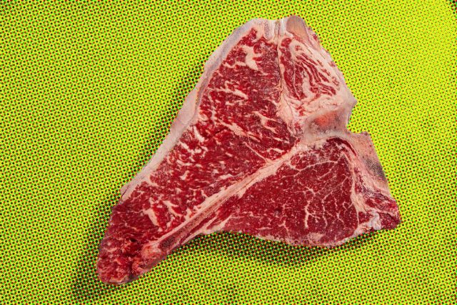 T-bone steak on yellow surface, Aussie style.