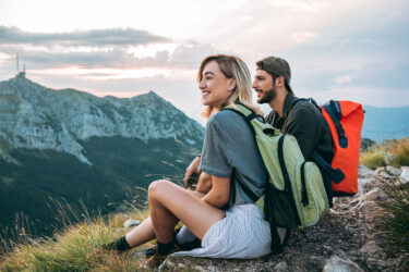 Young couple on a mountain embody growth.
