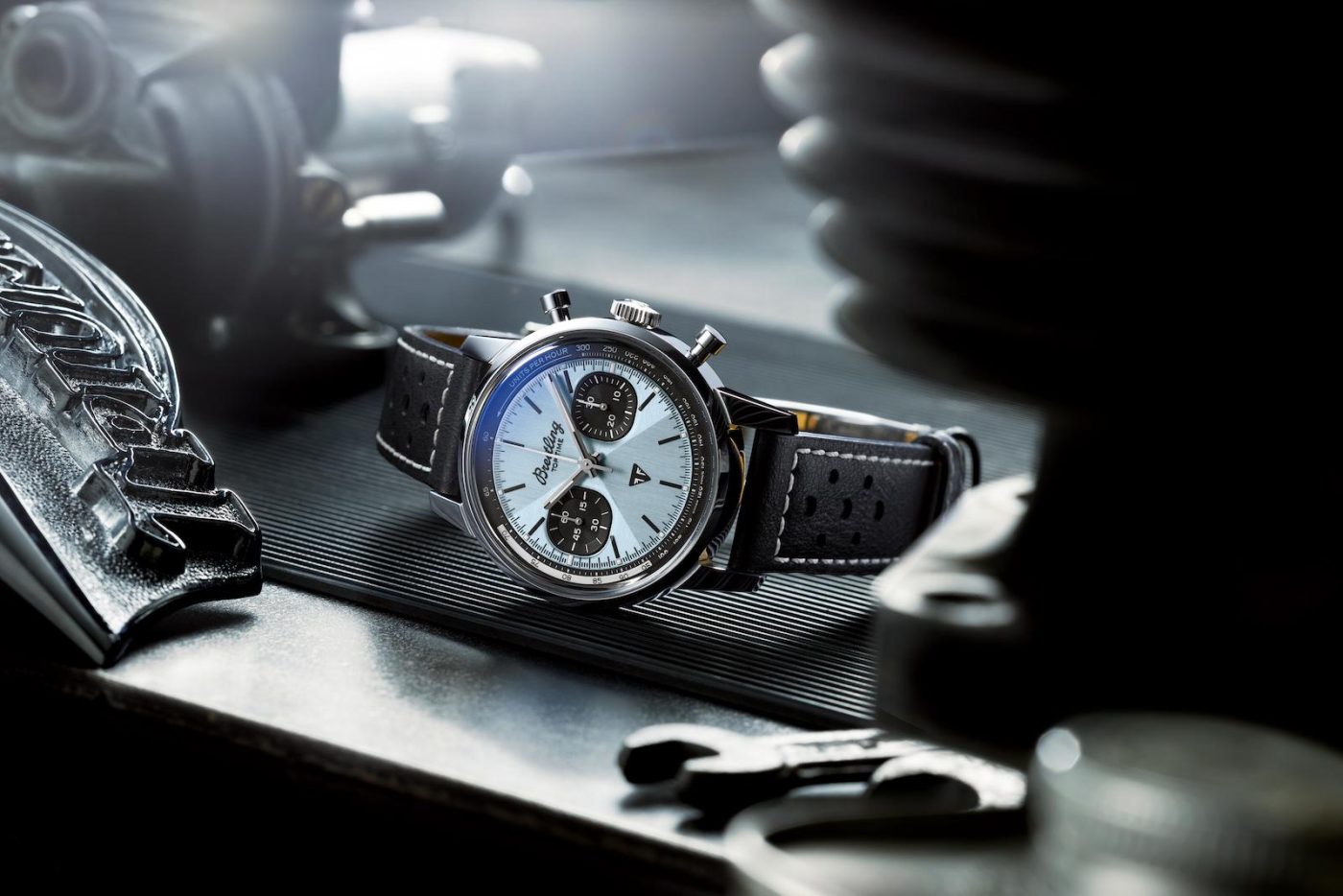 Breitling watch with dial, leather strap, tools.