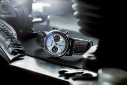 Breitling watch with dial, leather strap, tools.